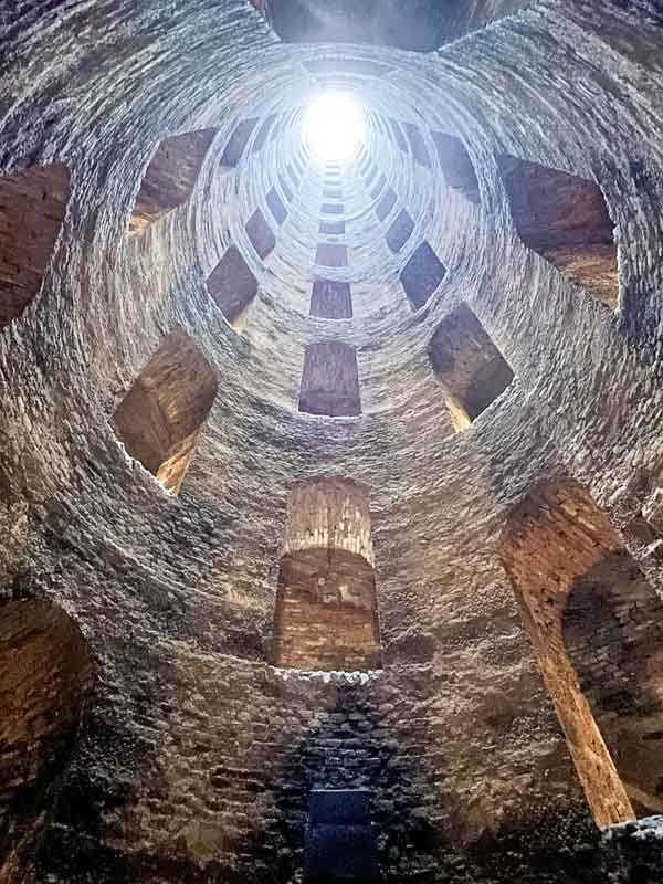 looking up a very deep old well of st patrick in orvieto with multiple openings