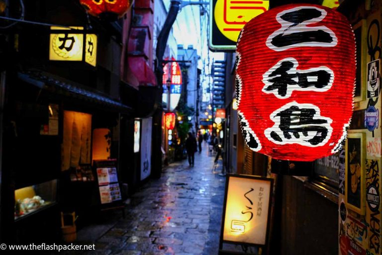 chinese lantern in cobblestone street in osaka at night