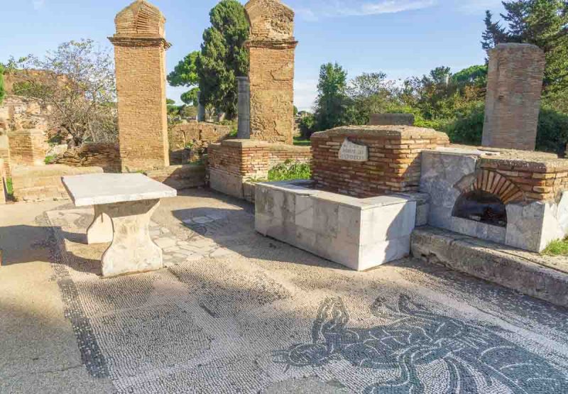 mosaic floor and marble counter and table in remains of fishmongers shop at ostia antica