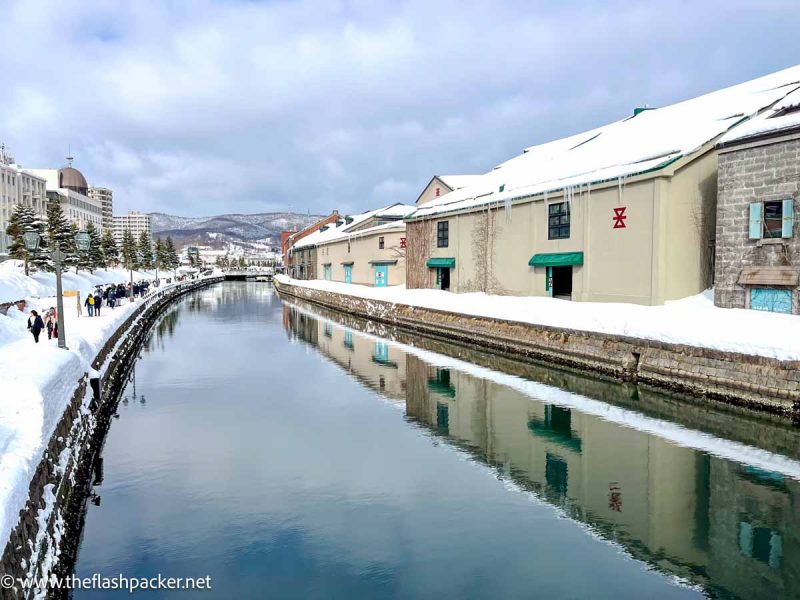 old warehouses reflected in a canal in otaru japan