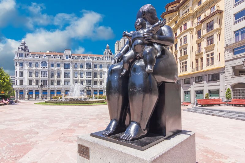 large square with fountain and modern sculpture in  the city of oviedo spain