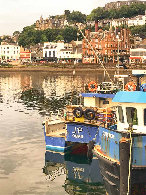 small blue amd white boats in harbour in oban