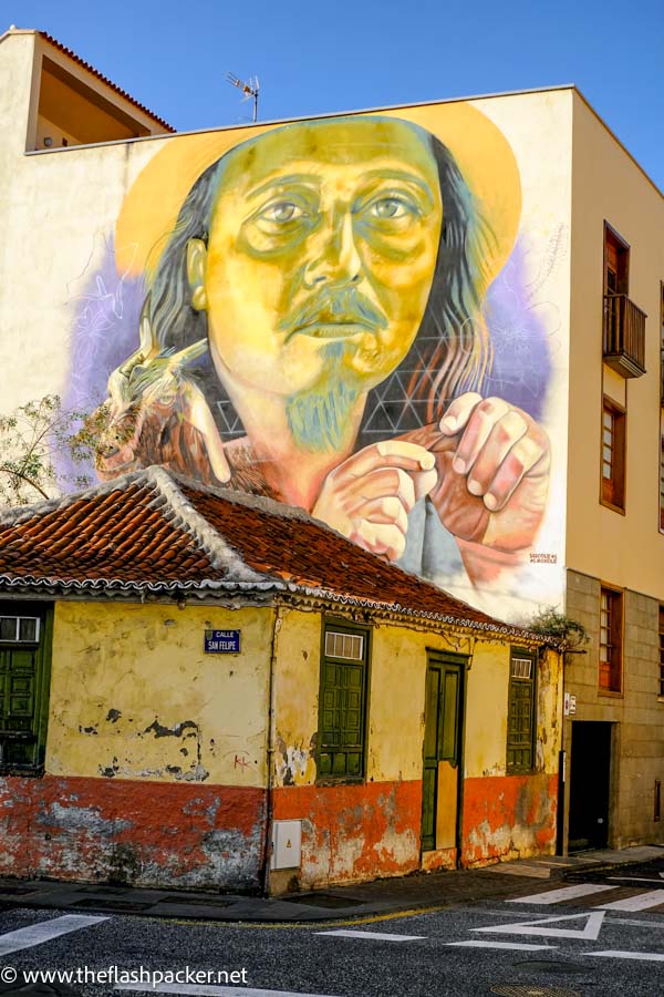 large mural of a man's face on the side of a building in puerto de la cruz tenerife