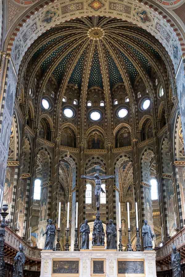 main altar of padua st anthonys basilica with a large crucufix and sculptures under a domed ceiling