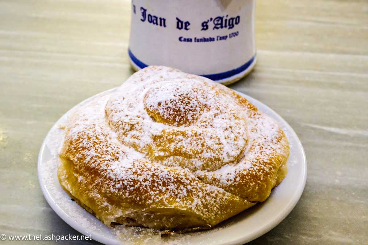 SPIRAL SHAPED PASTRY WITH MUG OF COFFEE