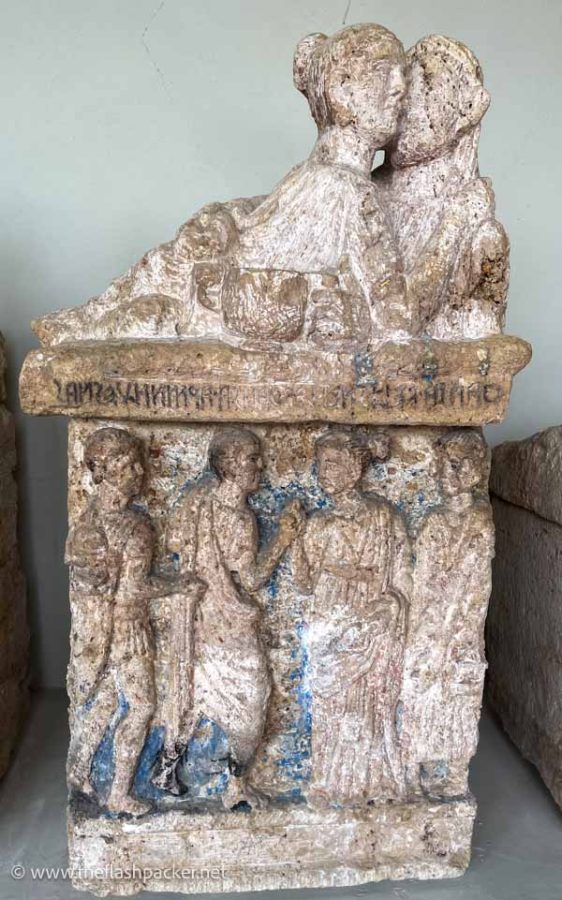 etruscan funerary urn carved with stone figures