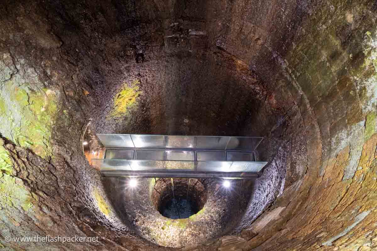 perspex walkway across the head of a deep well