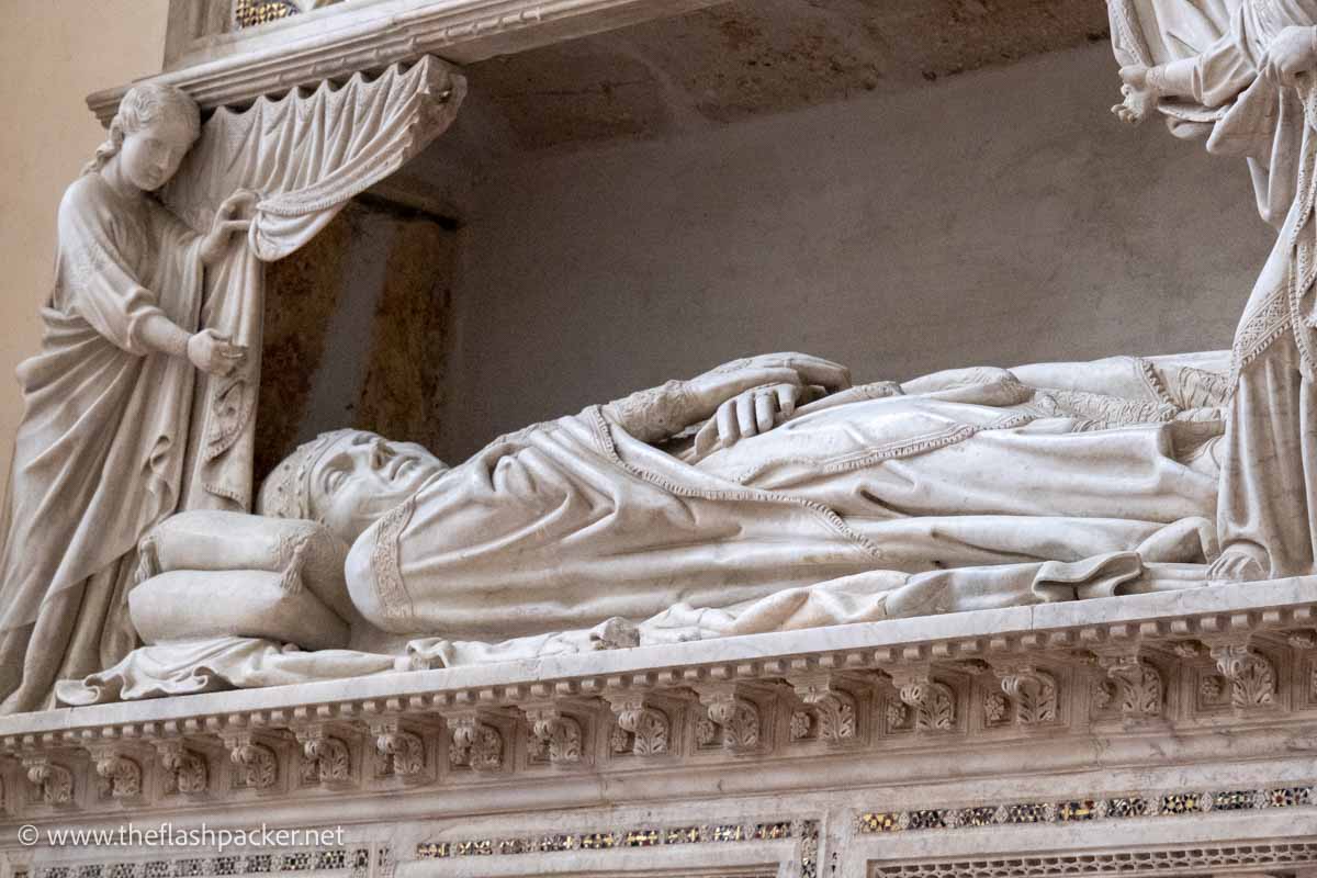 ornate tomb of benedict xi with effigy of sleeping pope and angel