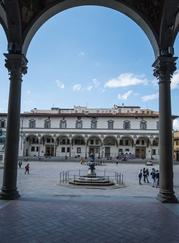 grand square in florence viewed though the arch of a portico