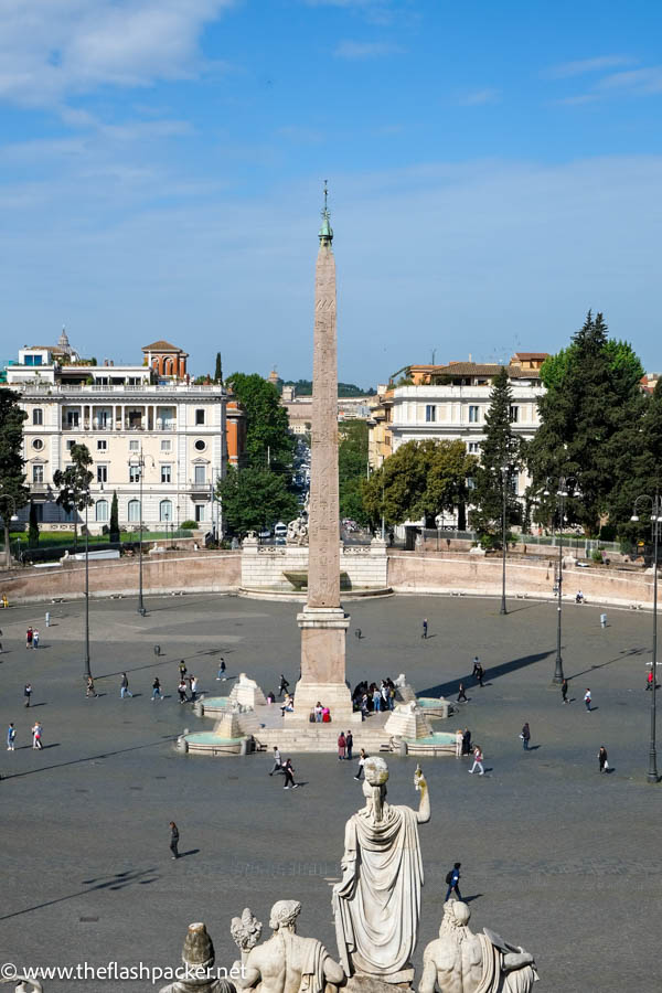 statues and tall obelisk in the centre of a large square in rome