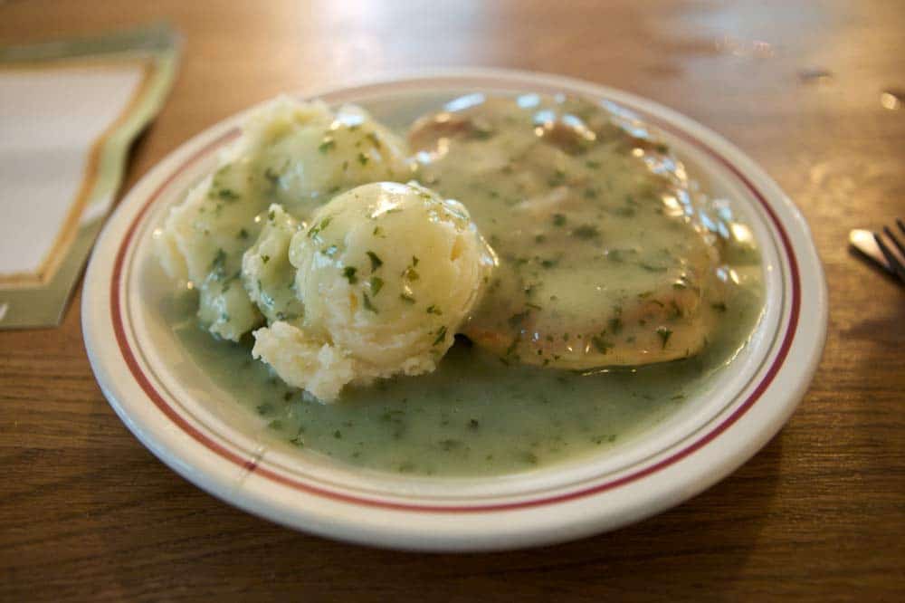 pie and mash potato covred by green liquor which is a traditional London food