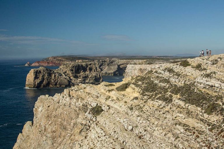 cliffs by coastline of portugal with deep blue sea