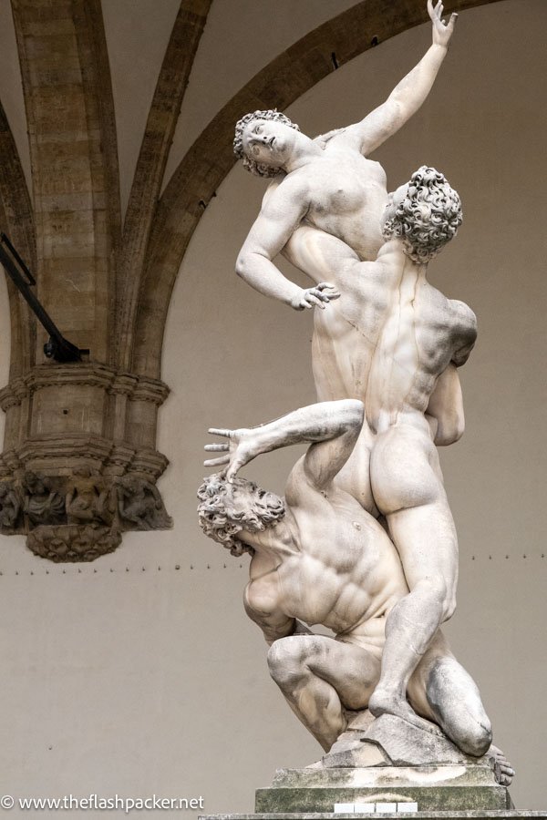 marble statue of three intertwined bodies