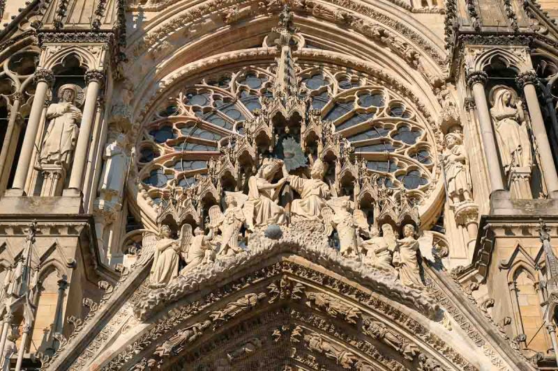 ornate sculptures above doorway of reims cathedral france