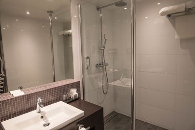 hotel bathroom with walk-in shower and sink