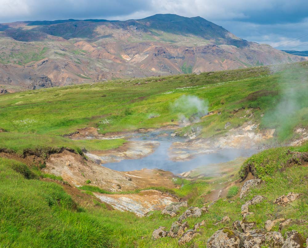 Reykjadalur valley with hot springs river and lush green meadow