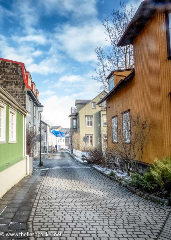 brightly coloured houses on cobbled street in old west side in reykjavik