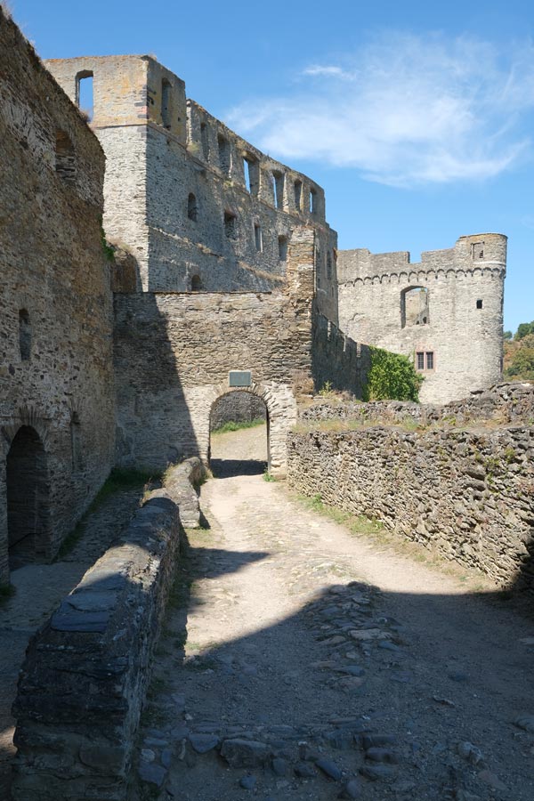 pathway along side of castle leading to a gateway