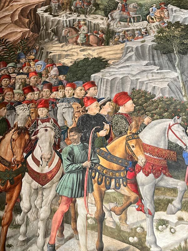 painting of procession of people and horses