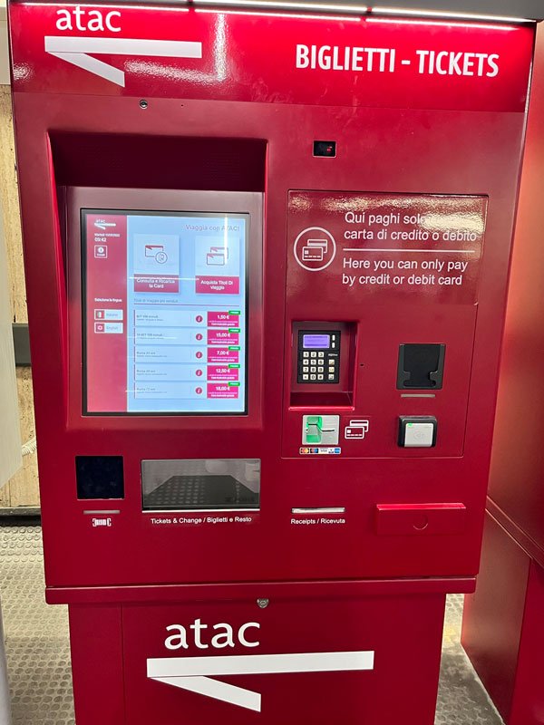 a red ticket vending machine in a rome metro station