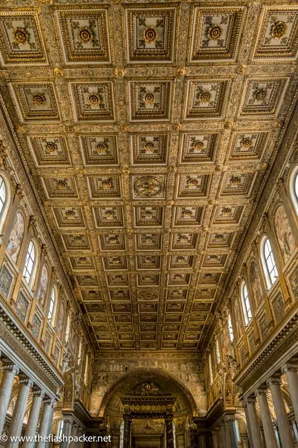 main aisle of church of s maria maggiore with gold ceiling and marble columns