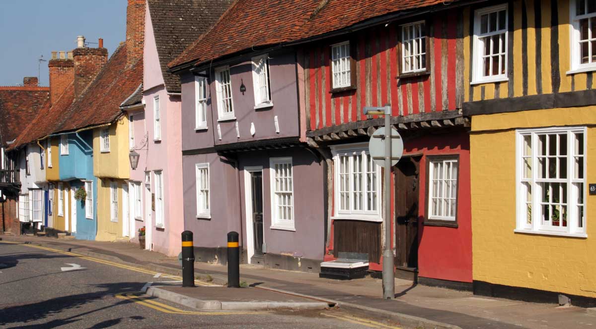 brightly coloured cottages lining a street in saffron walden