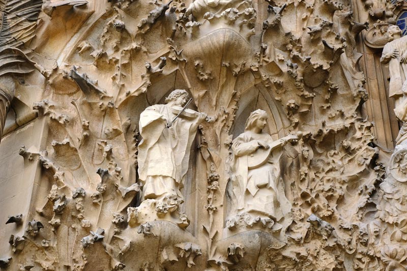 stone carving of two angels playing instruments