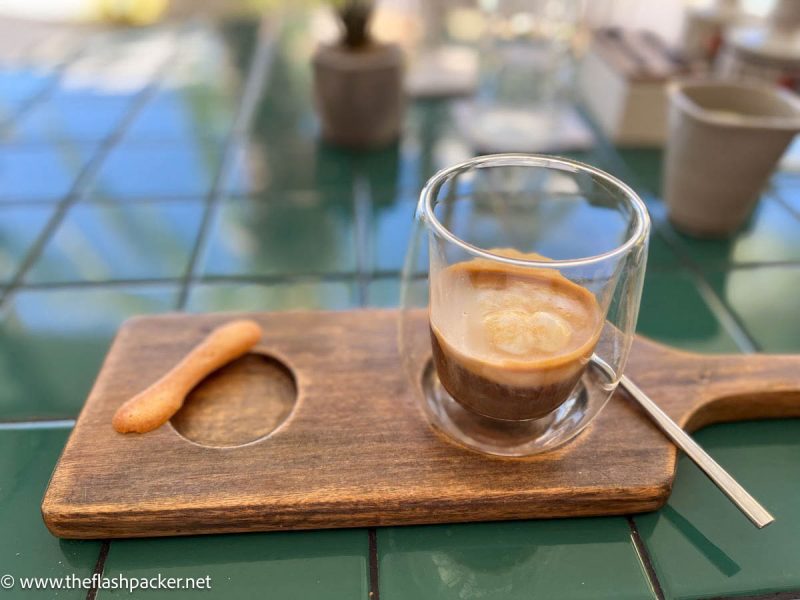 glass of coffee on a wooden paddle