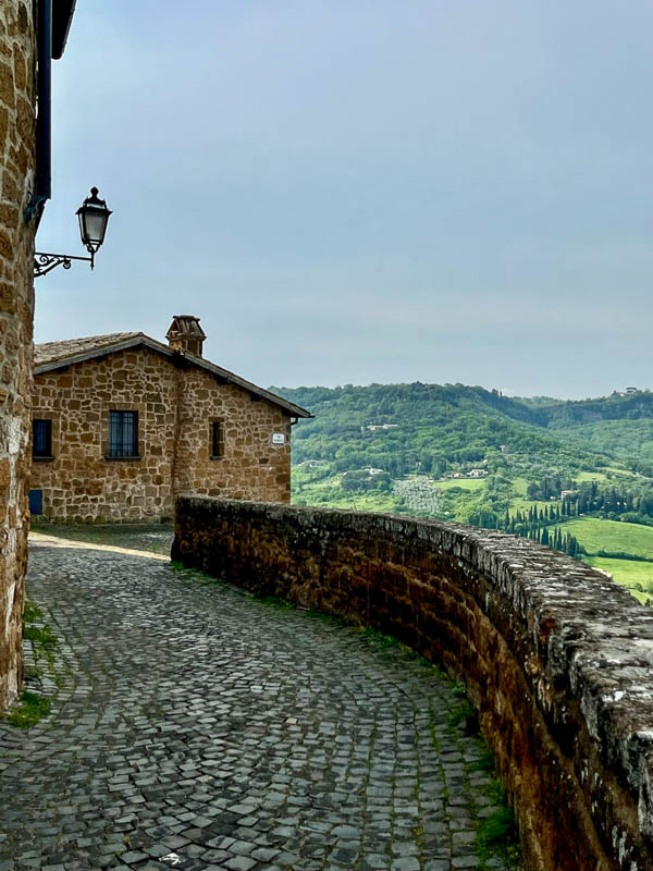 pretty cobblestone pathway overlooking beautiful view of rolling landscape