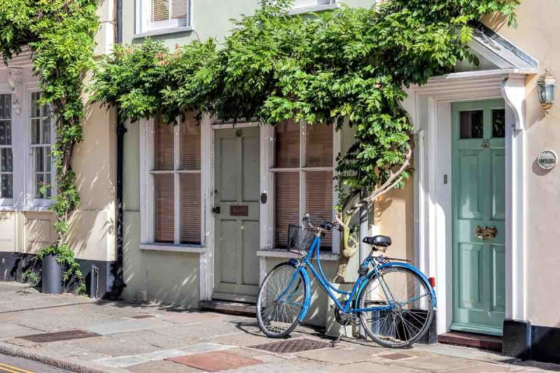 A blue bicycle leaning against a house in Sandwich Kent