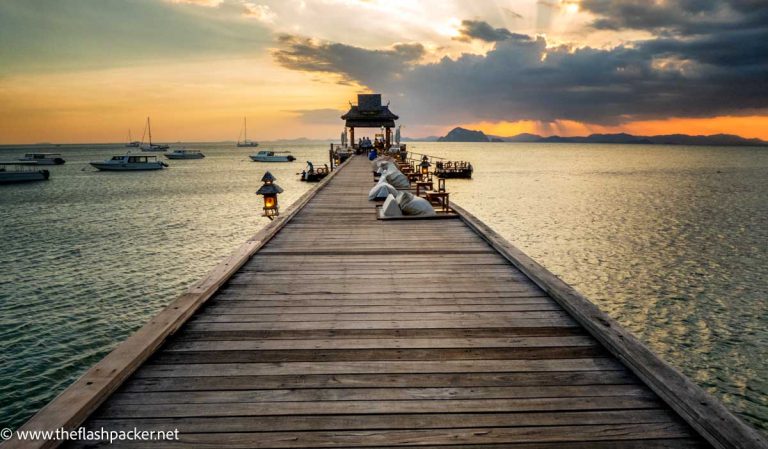 wooden pier reaching out to sea at sunset at santhiya-resort-koh-yao-yai