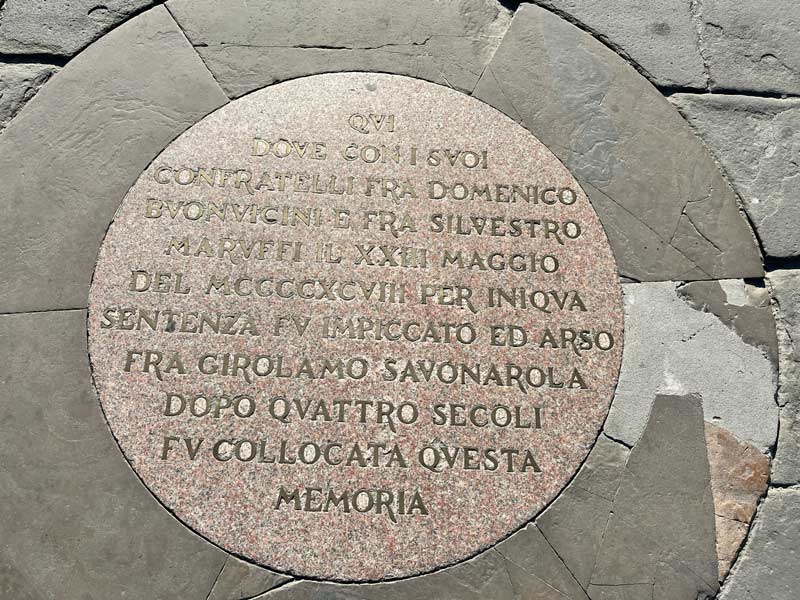 bronze commemorative plaque on pavement