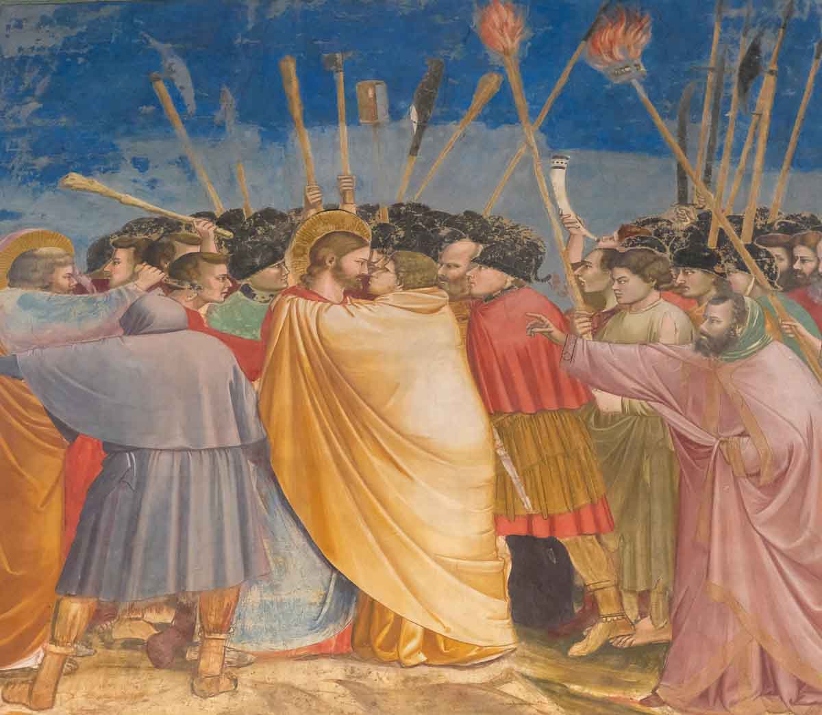 fresco by giotto of judas kissing jesus surrounded by soldiers