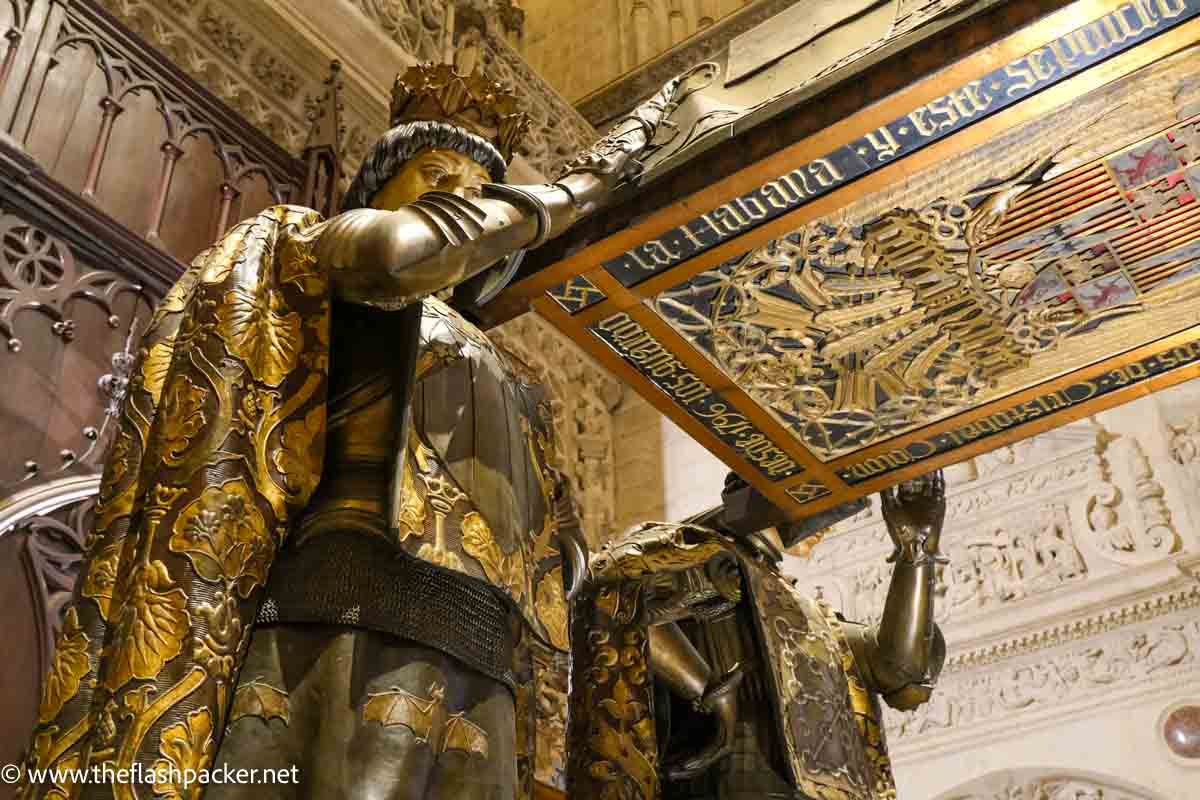 suculpture of men holding tomb of colon seen when visiting seville cathedral