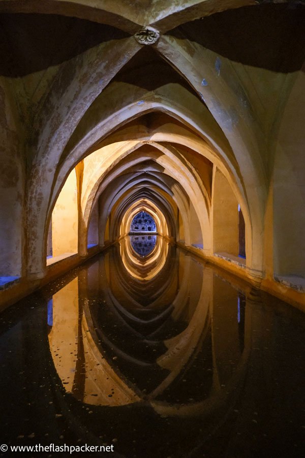 dimly lit underground baths with vaulted ceiling