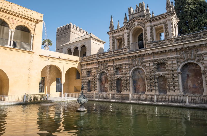 pond with founrtain and alcoves in wall with elaborate paintings