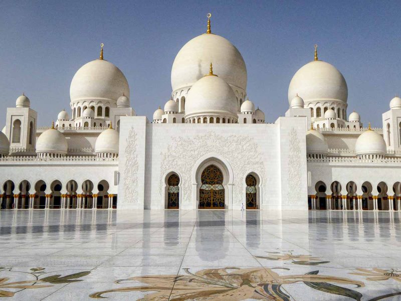 man walking in front of gleaming exterior of mosque during 3 days in abu dhabi