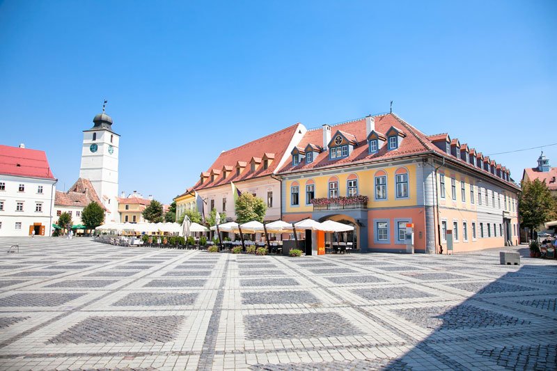 beautiful main square of sibiu romania with brightly coloured buildings