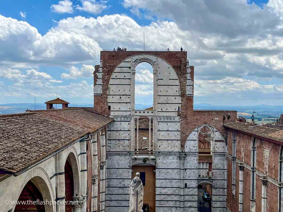 people standing on top of the unfinished church in siena