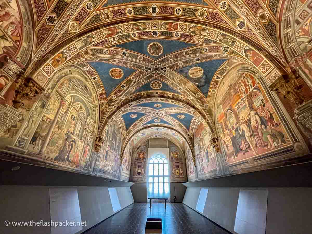 room with walls and ceilings covered in bright frescoes