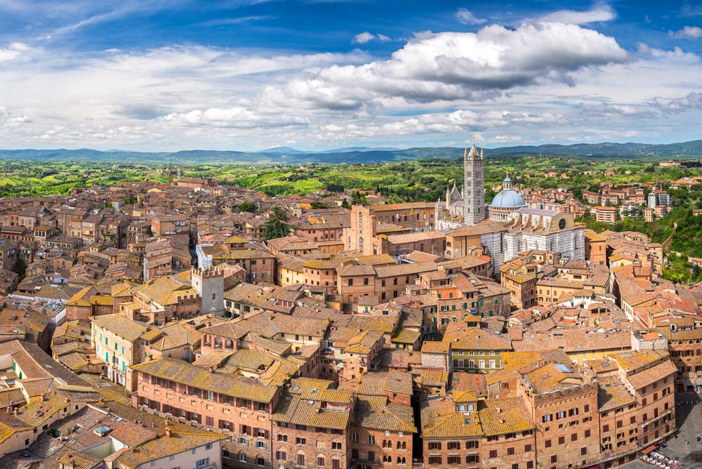 aerial view of the red roofs and shell shaped square in siena in tuscany