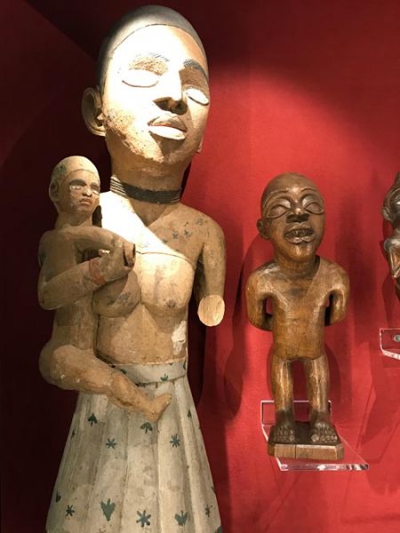 african sculptures displayed in a case