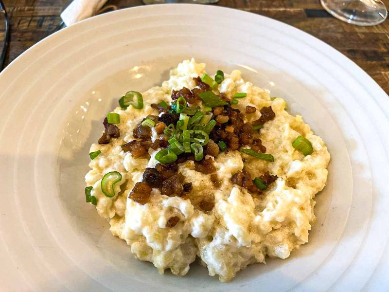 plate of slovakian dumplings topped with onion