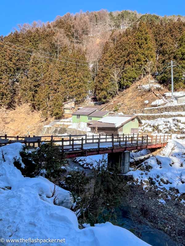 wooden bridge over a pretty snow covered gorge