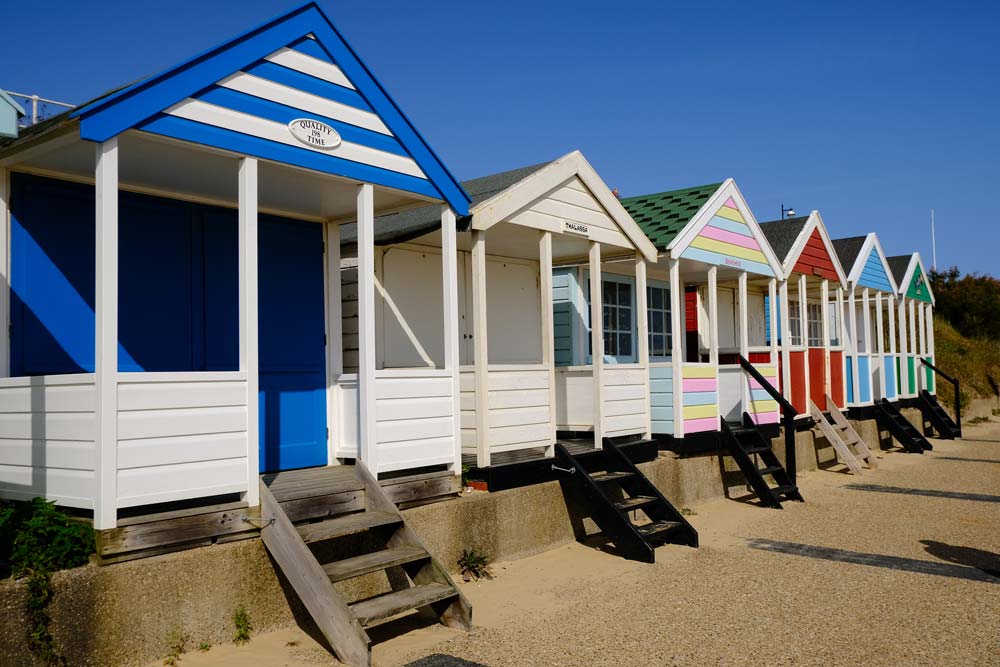 brightly coloured beach huts on southwold beach