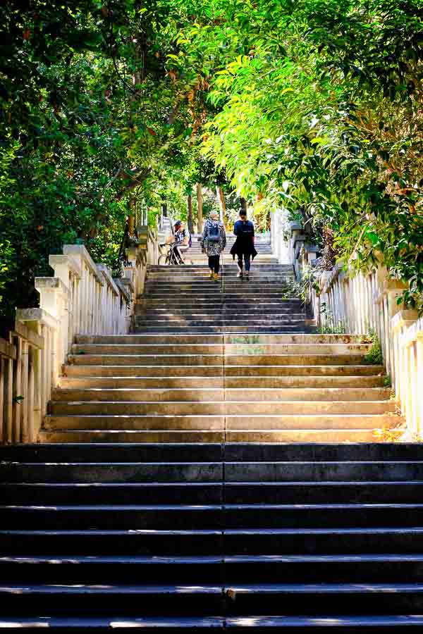 two women walking up a set of stone steps