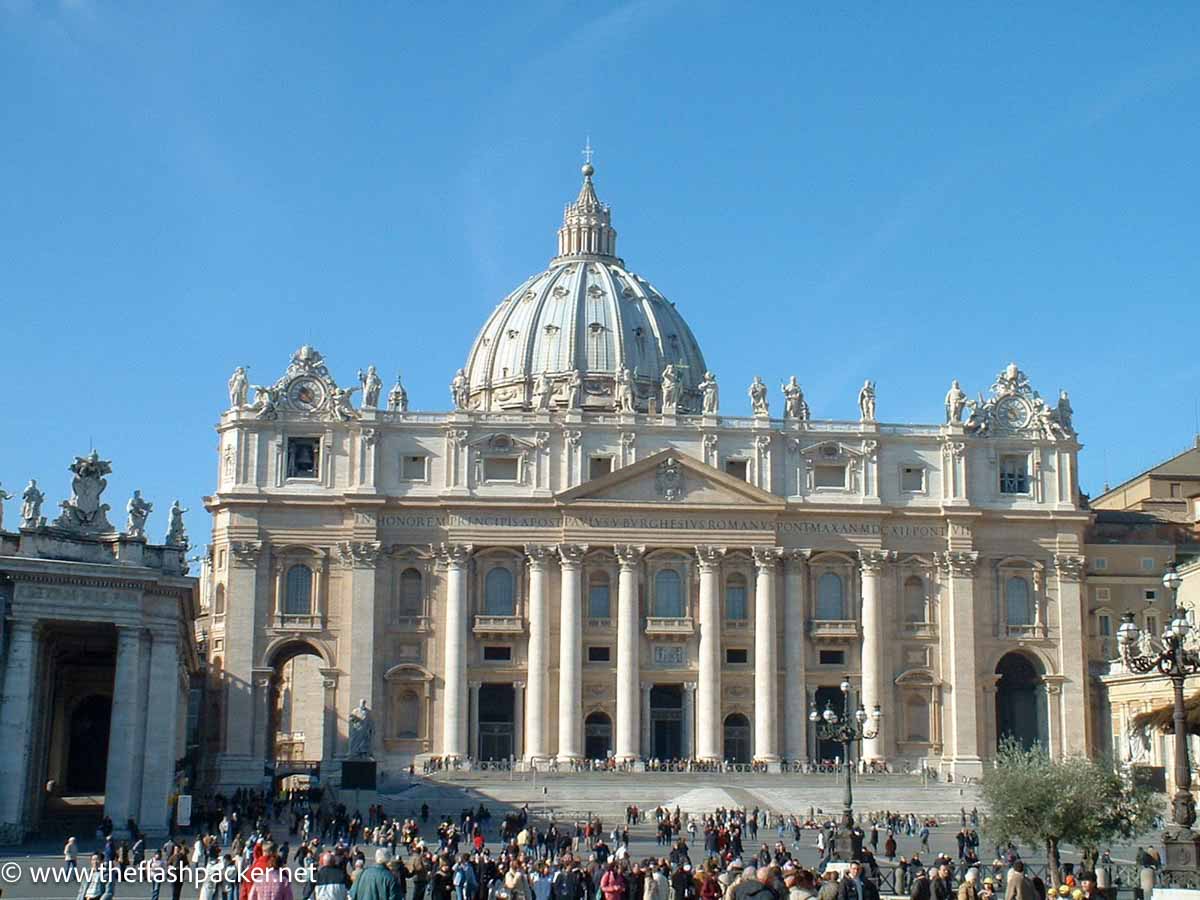 crowds of people outside the entrance to st peters basilican one of the things to see on a solo trip to rome