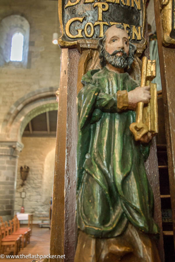 wooden statue of st peter with large key