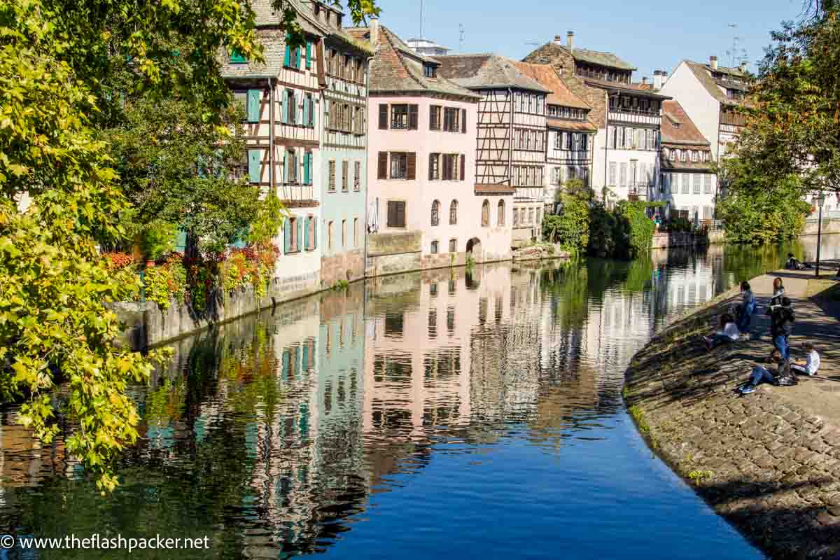 half timbered buildings reflected in canal in strasbourg france