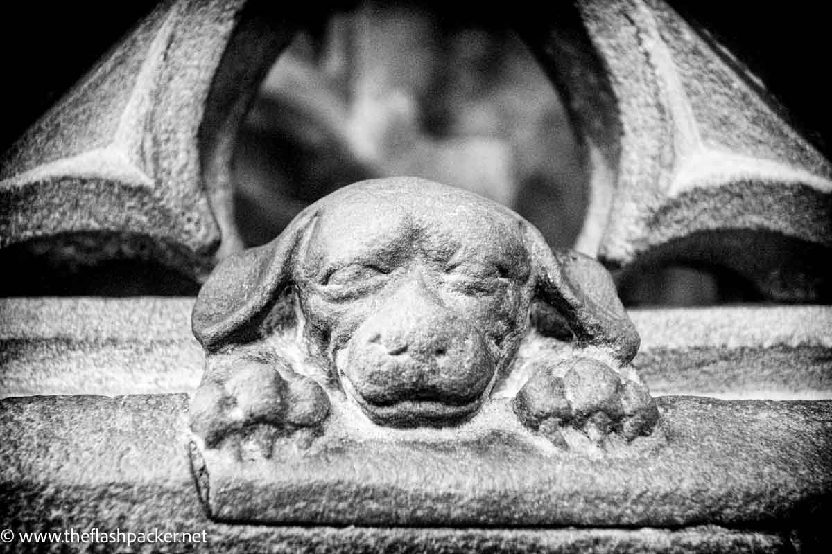 stone sculpture of sleeping dog